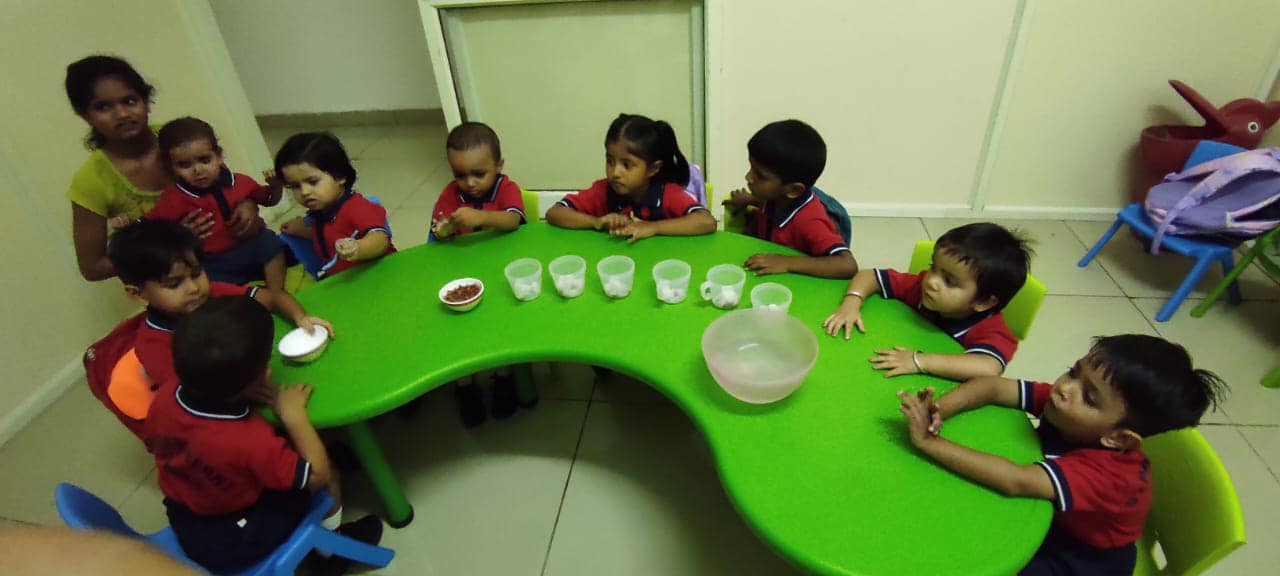 Children seated around activity table